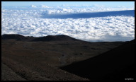 Follow the road back down to cloud level with the gentle slope of Mauna Loa in the distance.jpg