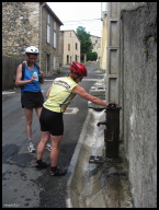 Filling our water bottles (quickly) at a high pressure communal street tap in Rodome.jpg