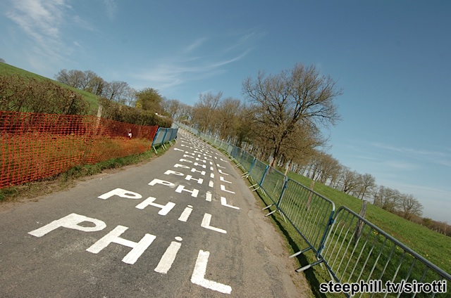 Philippe Gilbert riding over an endless set of "Phil" road stenciling...