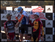 Wicks gets some help donning the overall winner's jersey.jpg